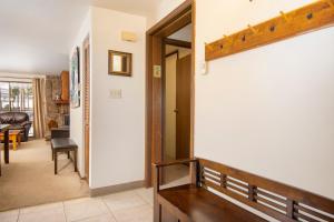 a hallway with a staircase leading to a living room at Beaver Village Unit #0221 in Winter Park