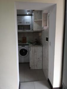 a small kitchen with a washing machine and a washer at Grig in Yerevan