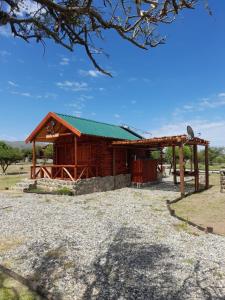 ein kleines Holzgebäude mit grünem Dach in der Unterkunft Portal de La Quebrada in Las Chacras