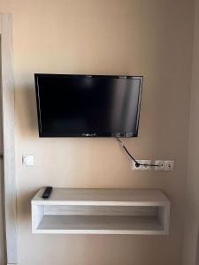 a flat screen tv hanging on a wall at Benalmadena Palace Spa in Benalmádena