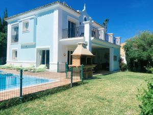 a villa with a swimming pool and a house at Detached Villa 4 bed Duquesa with Private infinity pool close to port and beach in Manilva