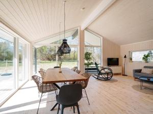 a living room with a wooden table and chairs at 8 person holiday home in Hundested in Hundested