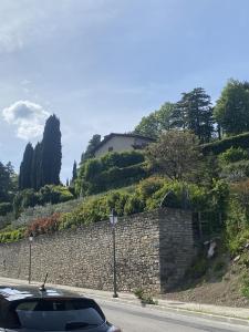 a car driving down a road next to a stone wall at Bed&Wine in Brisighella