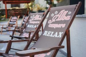 a row of lawn chairs lined up against a wall at Alba Camere Chiomonte in Chiomonte