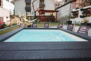 a large swimming pool with chairs in a yard at Alba Camere Chiomonte in Chiomonte
