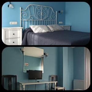 1 dormitorio con paredes azules y 1 cama con escritorio en Hostal San Antonio, en Íscar