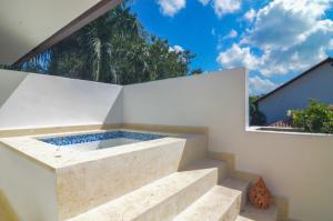 a plunge pool in a white wall with stairs at Six Bedrooms Luxury Disco Room Villa in La Romana