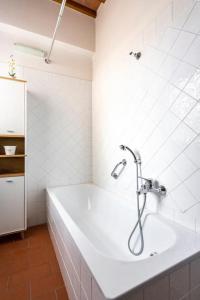 a bathroom with a bath tub with a shower at La Casa nel Borgo 418 con garage in Montespertoli