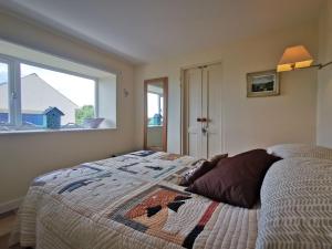 a bedroom with a bed and a large window at Tan Y Ffordd in Morfa Nefyn