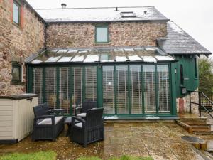 a greenhouse in the backyard of a house at Skomer Cottage in Haverfordwest