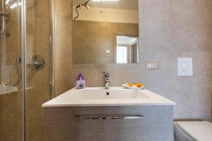 a bathroom with a sink and a shower with a mirror at Casa Bepi in Tremosine Sul Garda +28 photos