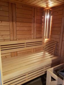 a wooden sauna with a light in it at La Casa des Frangins in Saint-Romain-de-Colbosc
