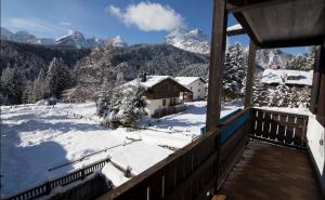 a room with a view of a snow covered mountain at Residence Borgo Al Sole in Sappada