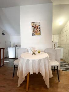 a table with a white table cloth on it in a kitchen at Jenny's Apartment in Mostar