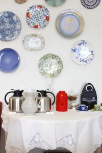 a white table with plates on a wall at Magnolia Guesthouse in Lisbon