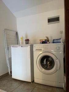 a white washer and dryer in a room at Jenny's Apartment in Mostar
