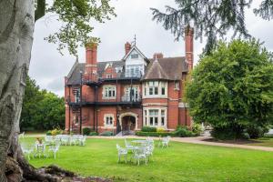 a large house with tables and chairs in front of it at Berwick Lodge in Bristol