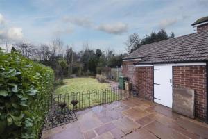 a brick house with a gate and a yard at 4 Bed in the heart of Hartford in Hartford