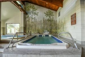 a swimming pool in a building with a tile wall at Pines 2045 in Keystone