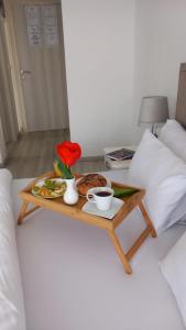a tray of food on a table on a bed at Lago d'argento sobe in Veliko Gradište
