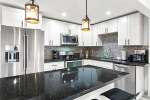 a kitchen with white cabinets and a black counter top at Hillside in Seattle - updated and well appointed. in Seattle
