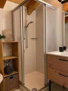 a shower with a glass door in a bathroom at Edelweiss -229- in Mittenwald