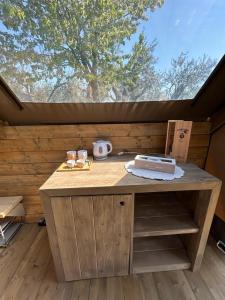 a wooden table with a cake on top of it at GLAMPING SUITE IL GRILLO in Lamporecchio