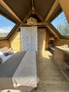 a bedroom with a large bed in an attic at GLAMPING SUITE IL GRILLO in Lamporecchio