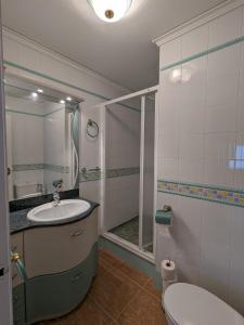 a bathroom with a shower and a sink and a toilet at Terraza con vistas al mar Parking privado 120 mts, junto a la playa in Cullera +47 photos