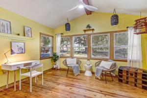 a home office with yellow walls and a desk and chairs at Downtown Gem- Dog Friendly Walk to Everything in Saint Augustine