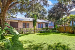a house with a fence and a yard at Downtown Gem- Dog Friendly Walk to Everything in Saint Augustine