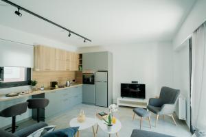 a kitchen and living room with chairs and a table at Comninon Suites in Ioannina