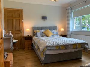 una camera con un letto, due lampade e una finestra di Bridgeview B&B a Ennis