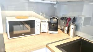 Kuchyňa alebo kuchynka v ubytovaní Résidence Anthérieu - Appartements neufs tout confort