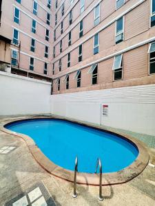 a swimming pool in front of a building at Lime Hotel in Patong Beach
