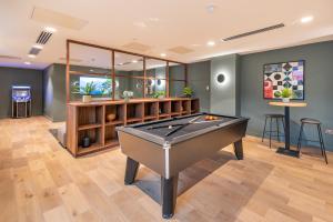 a pool table in a room with a bar at Niche Living - Dun Laoghaire in Dublin