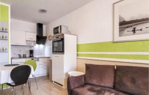 a living room with a couch and a kitchen at Nice Apartment In Börgerende With Wifi in Börgerende-Rethwisch