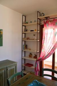 聖特雷莎加盧拉的住宿－Charming flat in Santa Teresa Gallura，一间带桌子和书架的用餐室