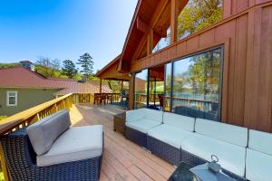 a patio with a white couch on a wooden deck at The Lake House in Jacksboro