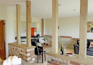 a kitchen and living room with a brick fireplace at Pheasant in Saint James