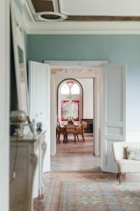 a hallway with a table and a dining room at Maison Jullian in Béziers