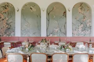 a dining room with tables and chairs and floral wallpaper at Maison Jullian in Béziers +68 photos