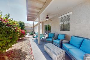 a patio with blue couches and chairs on a house at Peoria Magic in Peoria