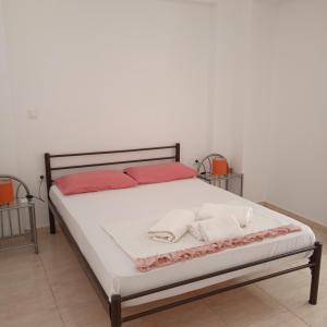 a bedroom with a bed with two towels on it at Sarakinos Apartments in Barbati