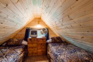 een kamer met 2 bedden en een tv in een blokhut bij North Fork Cabin in Cle Elum