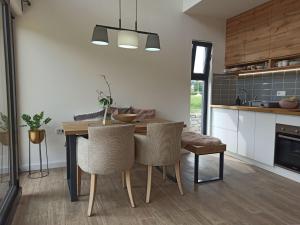 a kitchen with a dining room table and chairs at Bruka house Vrujci in Gornja Toplica +20 photos