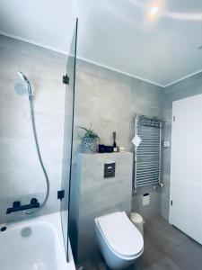 a bathroom with a toilet and a shower and a sink at Easy Stay in Keflavík