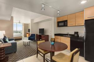 a kitchen and living room with a table in a apartment at Residence Inn by Marriott Fort Lauderdale Intracoastal in Fort Lauderdale