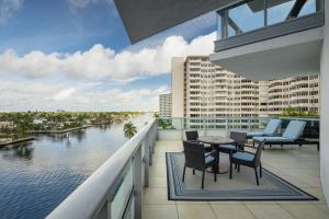 a balcony with tables and chairs and a view of a river at Residence Inn by Marriott Fort Lauderdale Intracoastal in Fort Lauderdale