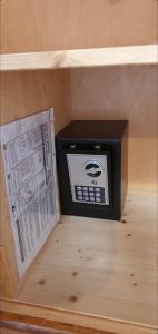 a small box in a wooden shelf with a newspaper at B&B Palace Basilico 1580. in Rovinj